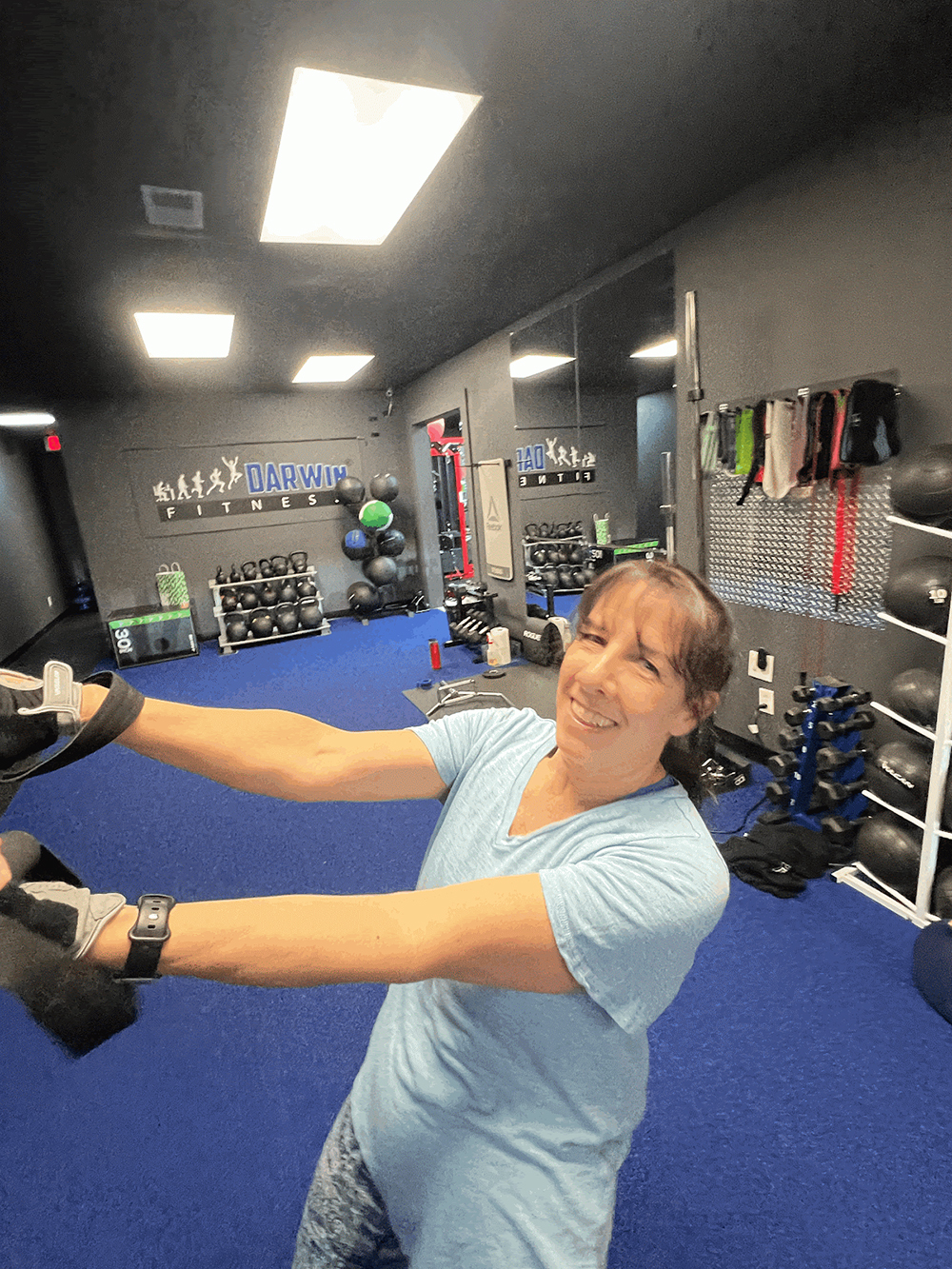 a smiling orwin manor area resident in mid-workout at darwin fitness private studio on lee road, demonstrating sustainable weight loss results achieved while balancing a professional career and social life along the mills 50