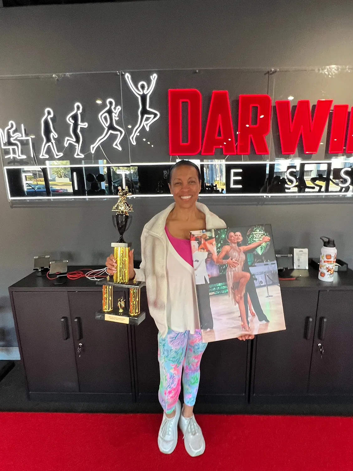 diedra, 62, from college park, holding her ballroom dance trophy after senior personal training